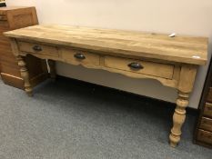 A reclaimed pine three drawer side table,