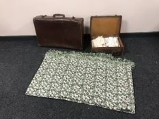 Two vintage leather cases containing children's clothes together with a woolen bed throw