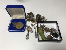 A collection of silver jewellery including brooch, ring, earrings and pendant, box of enamel badge,