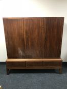 A mid 20th century teak triple door sideboard