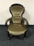 A late 19th century mahogany scroll arm armchair upholstered in dralon