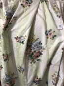 A pair of floral fully lined curtains