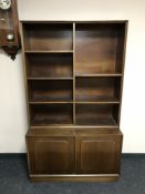 A set of open mahogany shelves with cupboard below