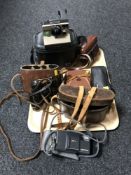 A tray of two pairs of leather cased binoculars,