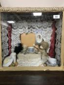 A china doll and pieces of Victoriana in display case