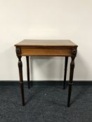 An early twentieth century mahogany occasional table on tapered legs