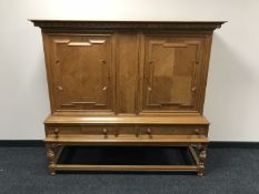 A continental oak double door sideboard
