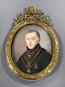 Early 19th century school, a miniature bust portrait of a gentleman wearing a medallion,