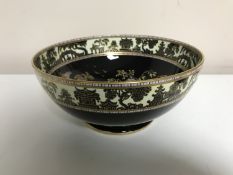 A Maling oriental style black and gilt fruit bowl pattern 3585, width 26 cm.