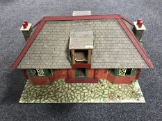 A mid twentieth century dolls house in the form of a bungalow