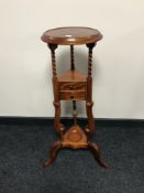 A reproduction wig stand in a mahogany finish