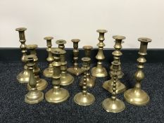 A tray of seven pairs of brass candlesticks