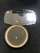 A frameless bevelled mirror together with a circular cream and gilt mirror