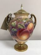 A Royal Worcester gilded lidded urn decorated with panels of fruit and berries, signed J.