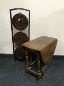 A small oak drop leaf occasional table together with an oak folding cake stand and a torchere