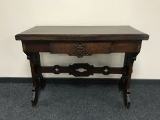 An early twentieth century oak church style hall table fitted with a drawer