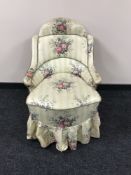 A 19th century bedroom chair, with shaped back, upholstered in floral fabric,