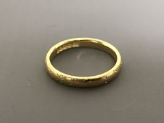 An 18ct gold wedding band