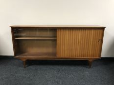 A 1970's teak sliding glass door bookcase