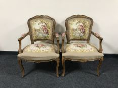 A pair of carved walnut framed armchairs
