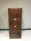 A wooden four drawer filing chest