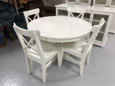 A white extending Ikea dining table and four chairs CONDITION REPORT: When closed