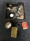 A vintage tin containing travel clocks, Oxo money box, bells, keys,