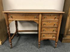 An Edwardian oak lady's desk fitted with five drawers,