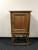 A continental oak cupboard on stand