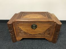 An Oriental carved camphor wood chest