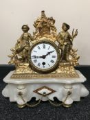 An antique French gilt mantel clock on marble plinth with enamelled dial