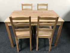 A contemporary pine kitchen table together with four chairs