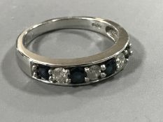 An 18ct white gold sapphire and diamond half eternity ring,