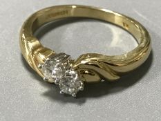 An 18ct gold two-stone diamond ring, approximately 0.2ct, size M/N.