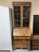 A 20th century walnut bureau bookcase on associated base