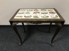 An oak tiled topped flap sided table on cabriole legs