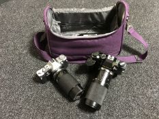 An Olympus OM30 with lens, an Olympus OM40 camera with lens,