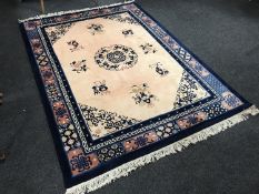 A fringed woollen Chinese rug on blue ground
