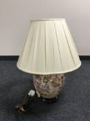 A china table lamp and shade on wooden base with fruit and flower decoration