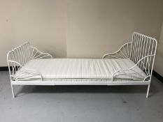 A 3' white metal day bed with mattress