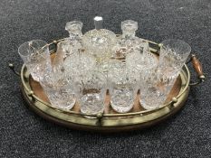 An oval oak galleried tray containing a glass trinket set and a set of six lead crystal glasses