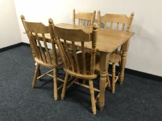 A pine effect dining table and four chairs