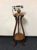 A vintage style telephone on two tier circular table