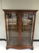 A Chapman's Siesta double door display cabinet in a mahogany finish