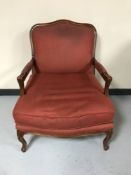 A wooden framed Wade armchair upholstered in red fabric