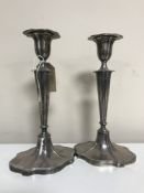 A pair of loaded silver candlesticks with sconces,