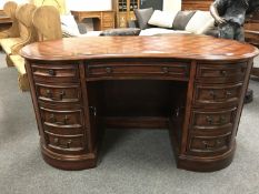 A reproduction mahogany kidney shaped pedestal desk,