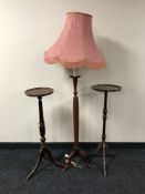 A mahogany effect torchere and a standard lamp with shade