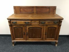 An Edwardian oak sideboard