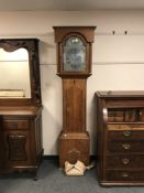 A continental oak eight day antique longcased clock with pendulum and weights